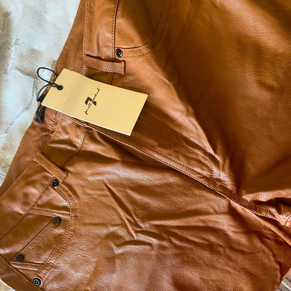 leather pants, never worn. flossing front button.